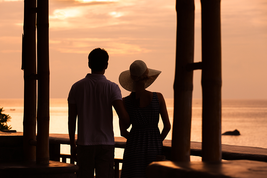 A happy couple watching a sunset on the Outer Banks and enjoying addiction recovery