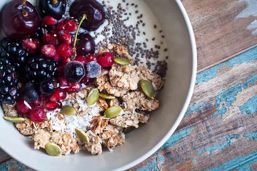 A bowl of healthy yogurt with fruit and nuts