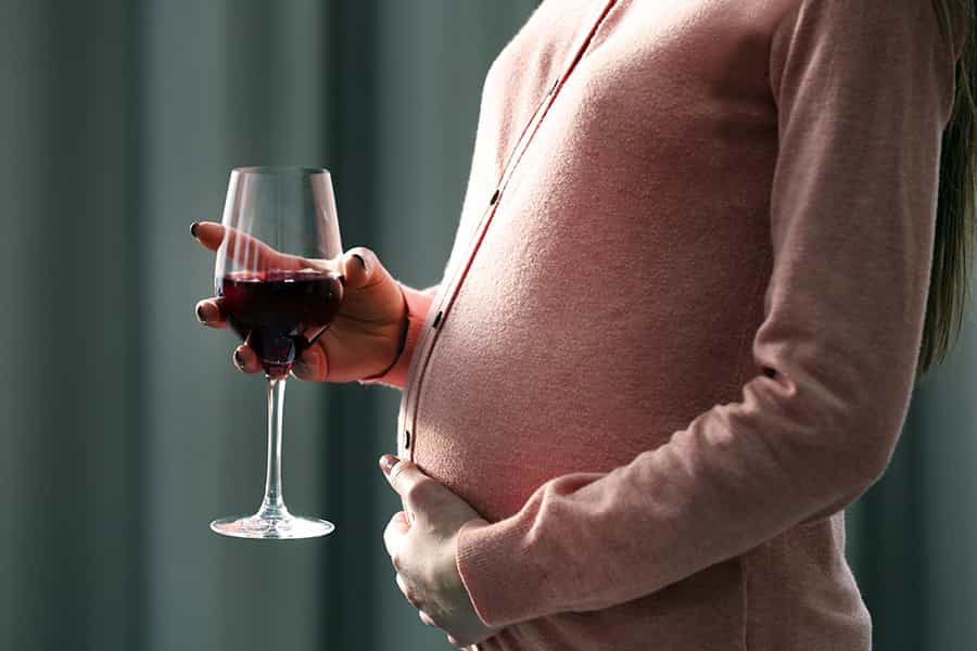 Pregnant woman drinking wine